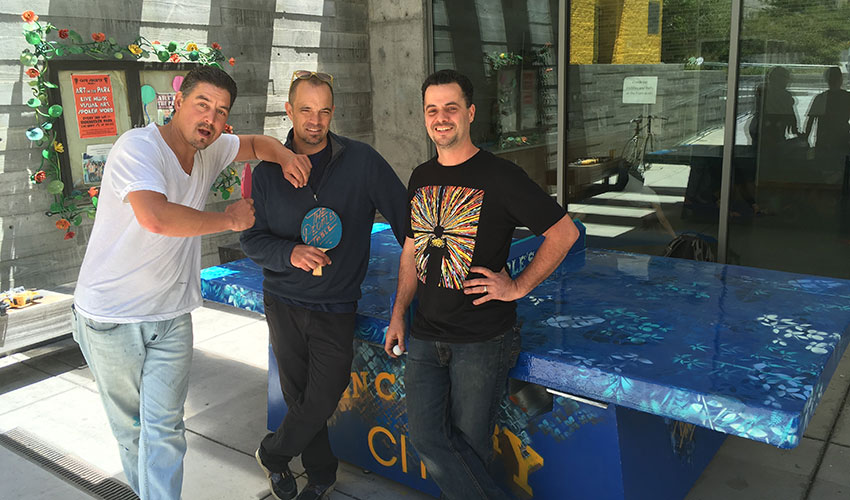 Photo: Schweitzer Fellow with two men in front of ping pong table